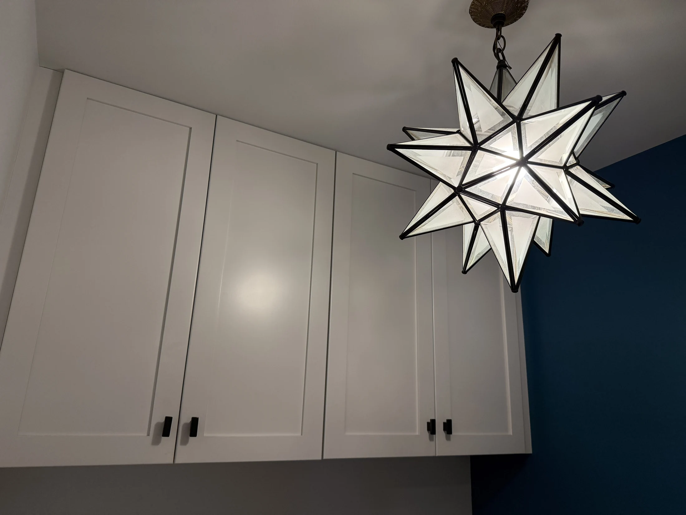 Laundry cabinetry and star-shaped ceiling light