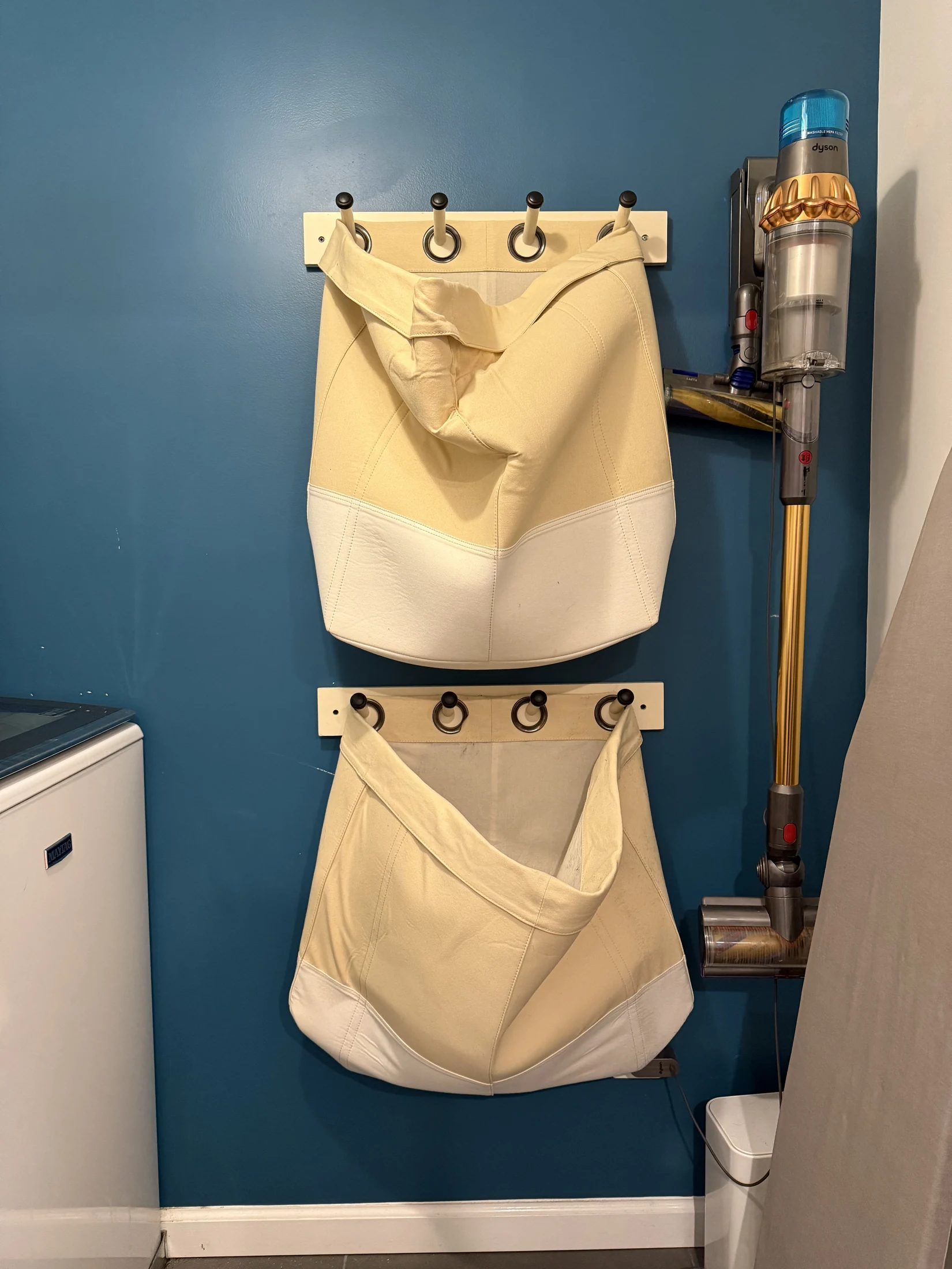 Laundry room organization on the blue accent wall