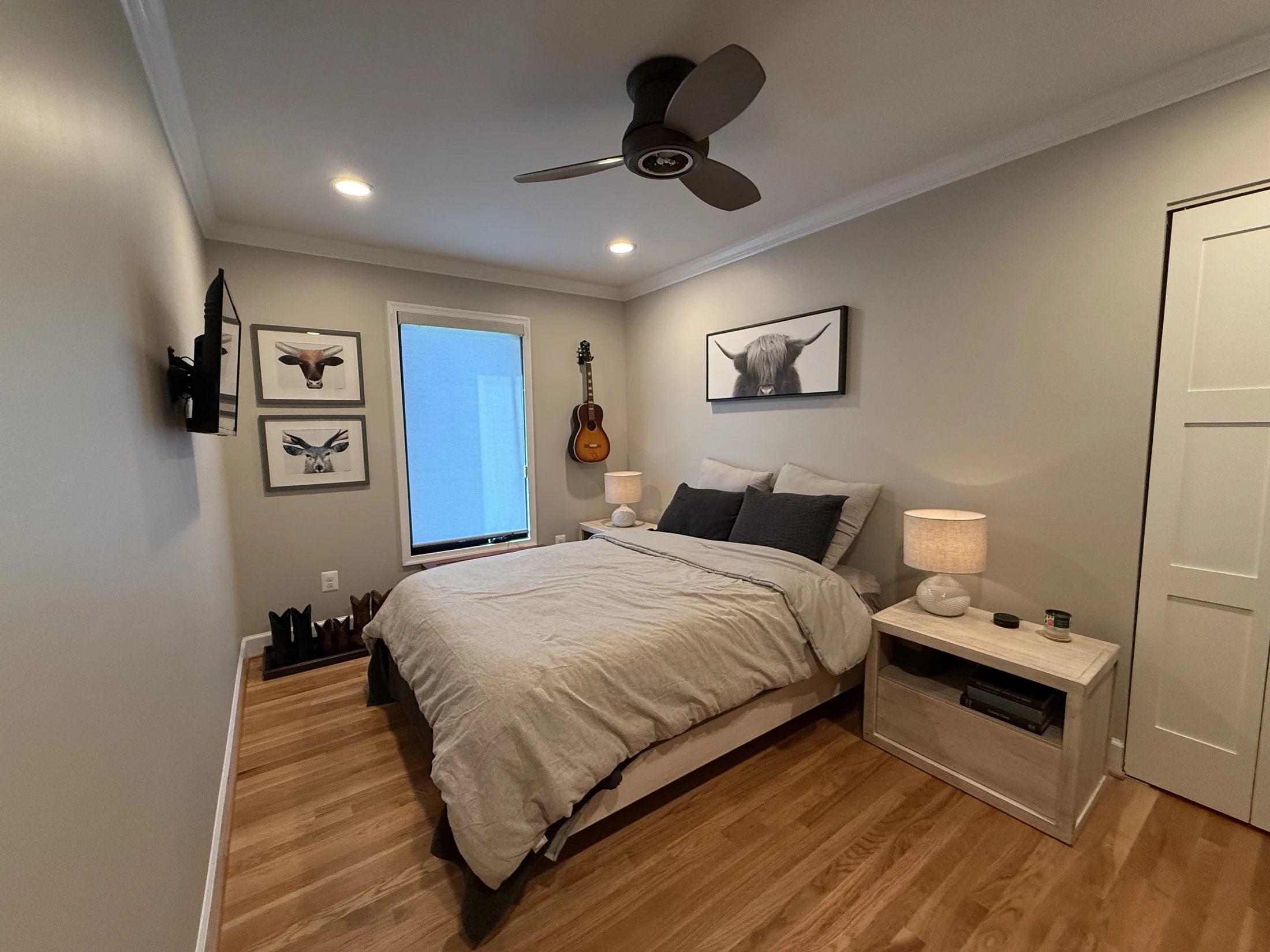 Remodeled bedroom with hardwood flooring