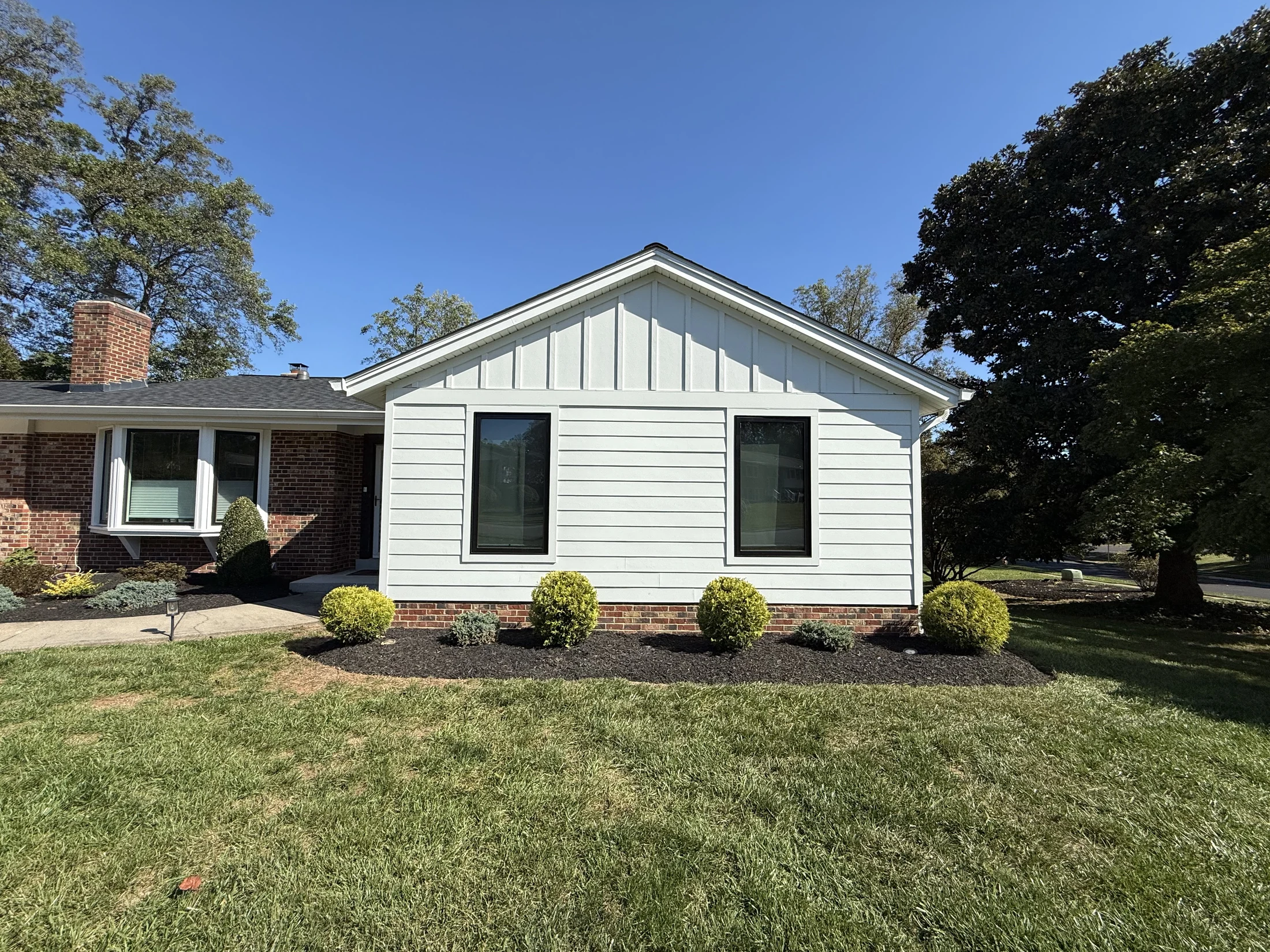 Front bedroom addition with a gabled roof and white siding