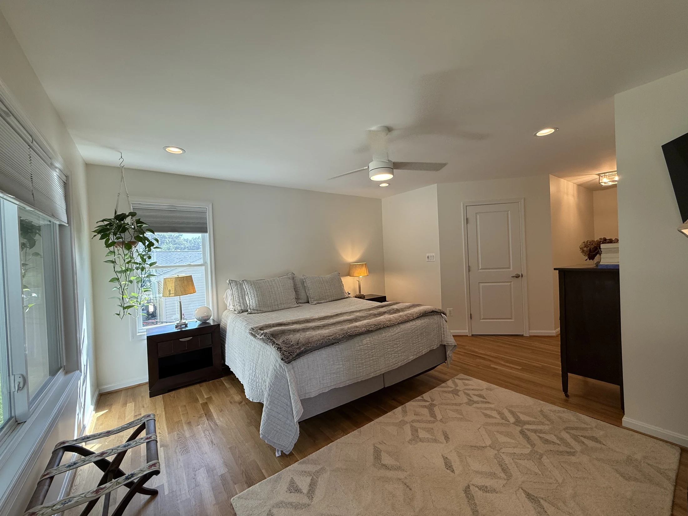 Primary bedroom with hardwood floors and garden views