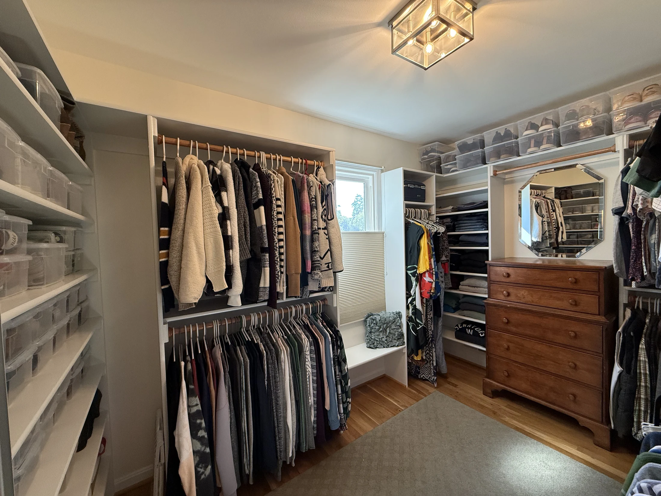 Walk-in closet with hanging space and open shelving