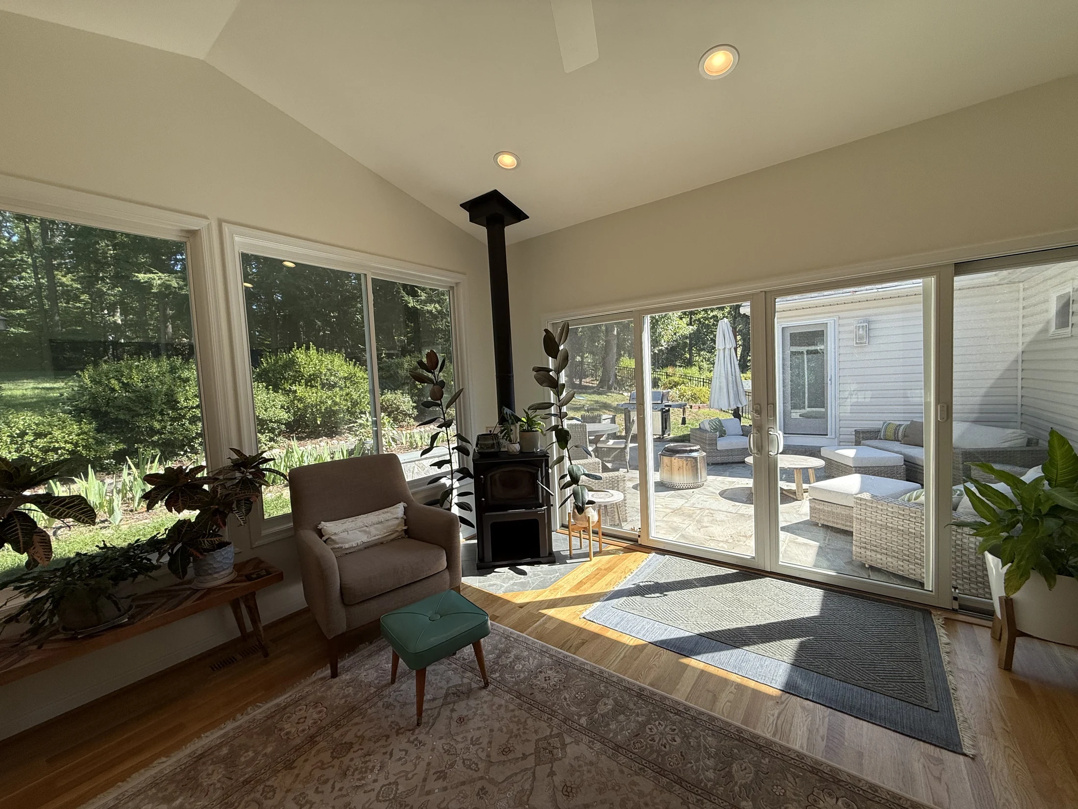 Vaulted ceiling and wood-burning stove beside the patio doors
