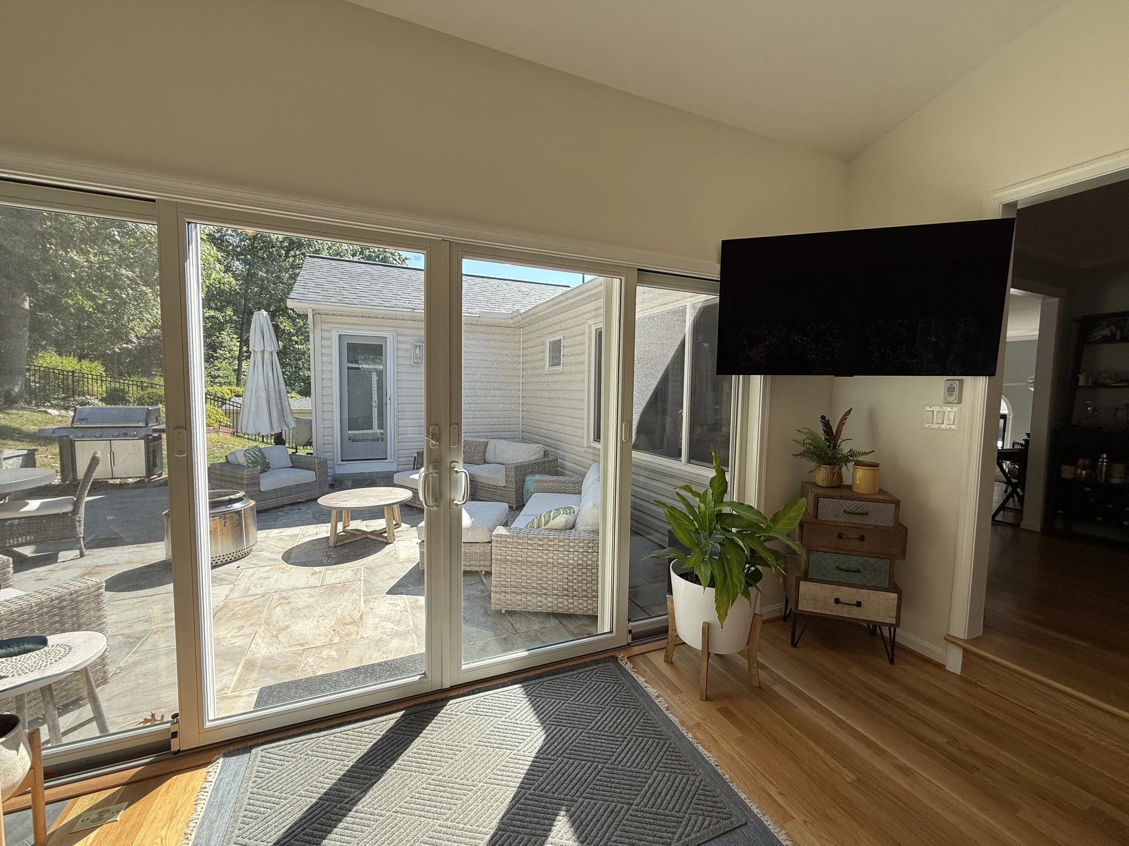 Sliding doors connect the sunroom to the patio