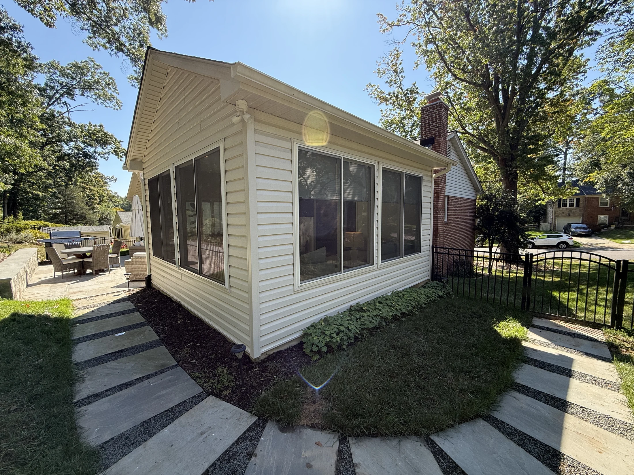 Sunroom exterior with tall windows and vaulted roofline