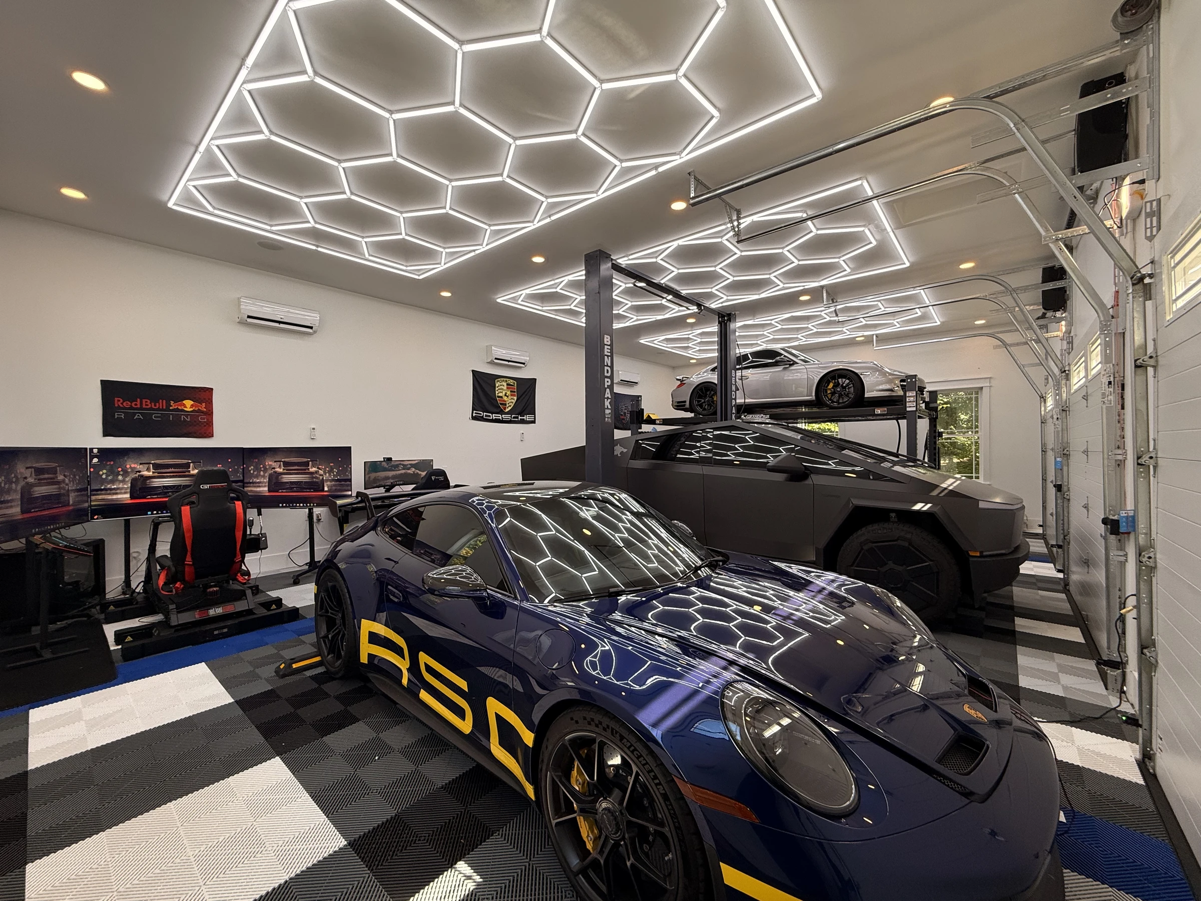 The Collector's Garage garage interior with hexagon lighting and cars